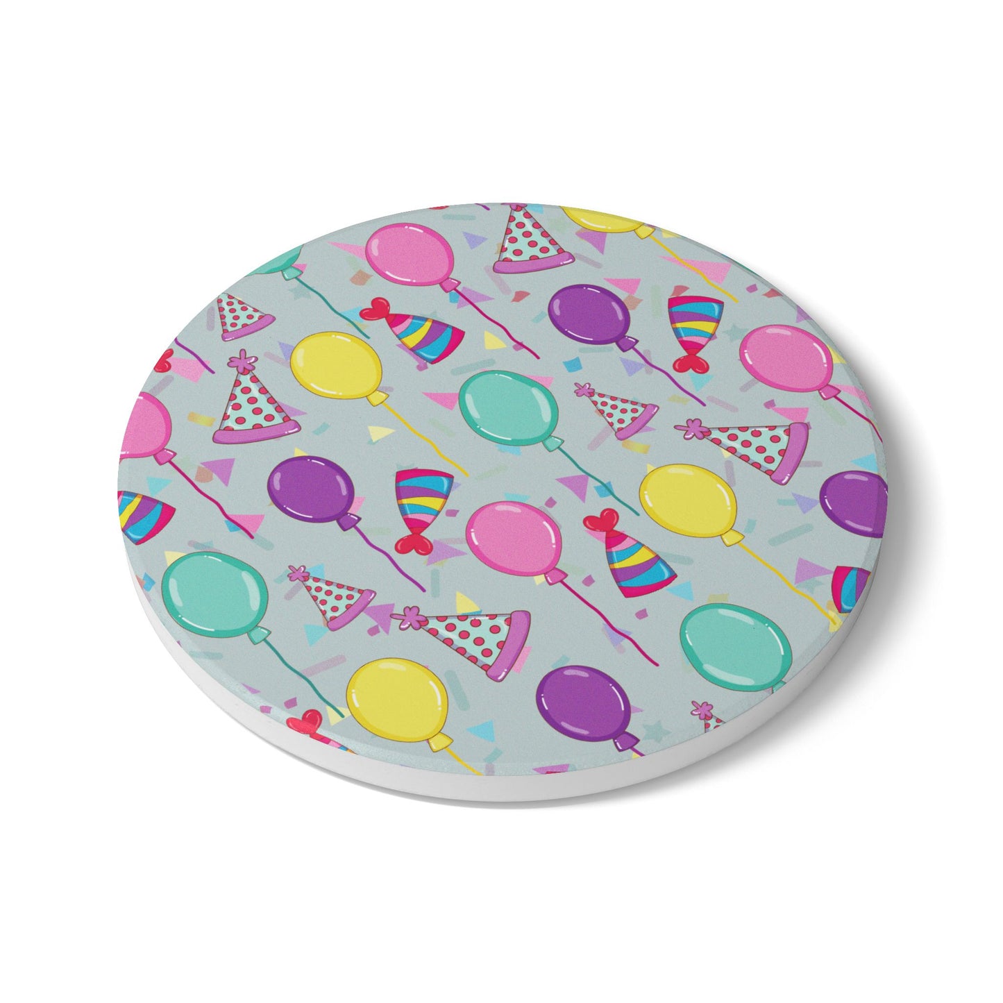 Happy Birthday round ceramic tile coaster with with birthday hats, confetti and balloons pattern with a blue-green light cyan background on white background