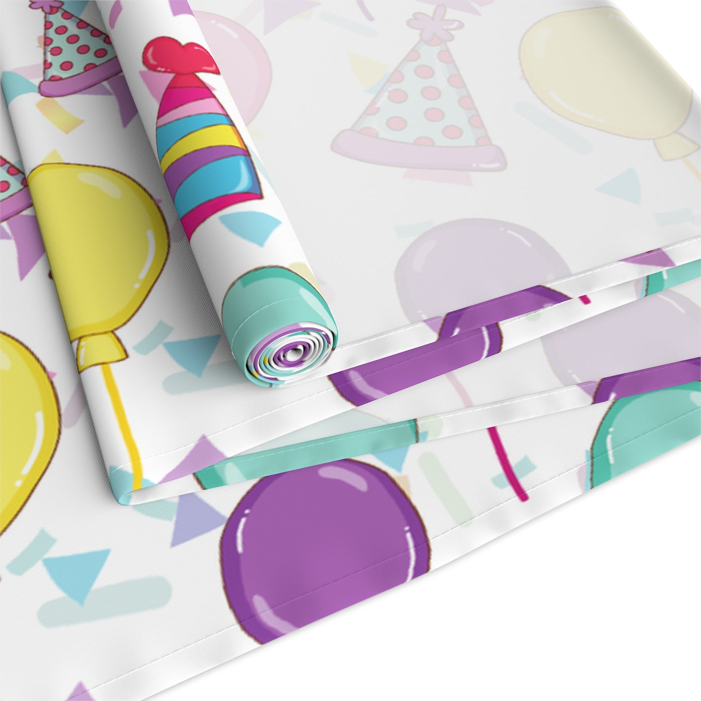 Rolled table runner with birthday hats, confetti and purple, yellow, blue and pink balloons design
