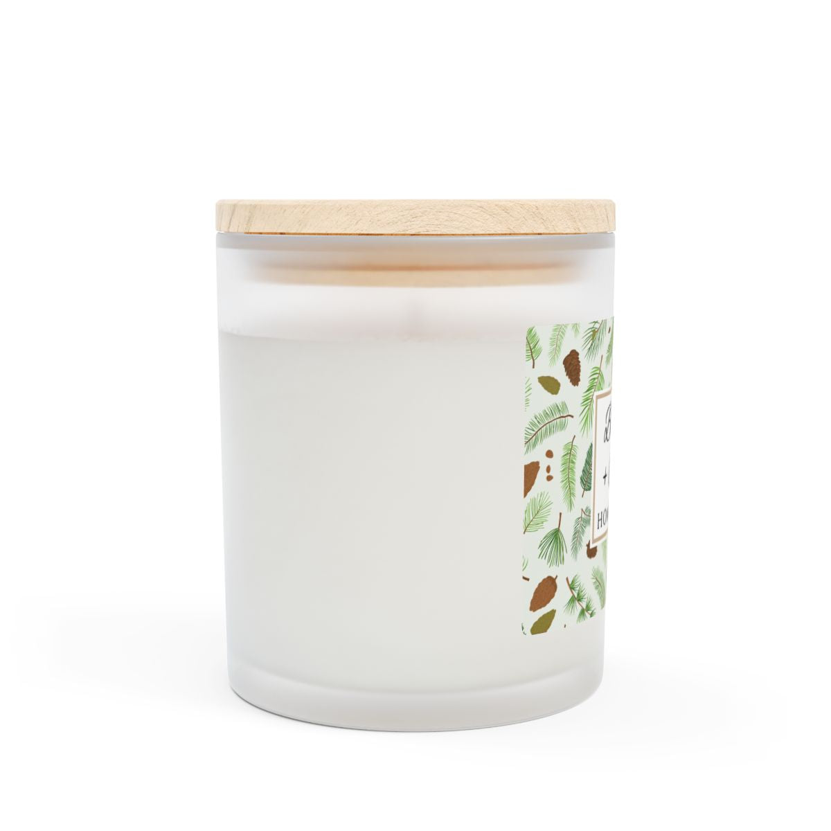 Side View of wood wick candle with 'Balsam + Cedar' label with cones and cedar leaves on a white background by Home & Wicks