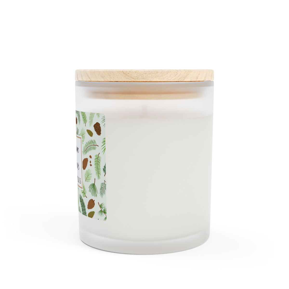 Side view of wood wick candle with 'Balsam + Cedar' label with cones and cedar leaves on a white background by Home & Wicks