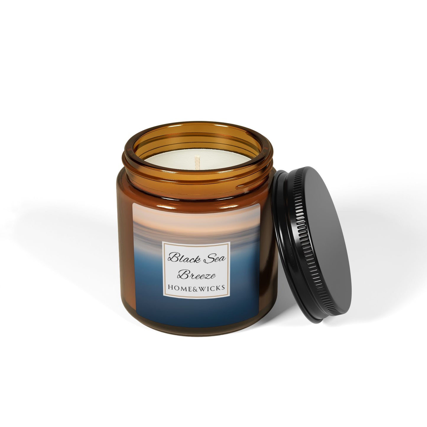 Candle in an amber jar with a visible label on a white background