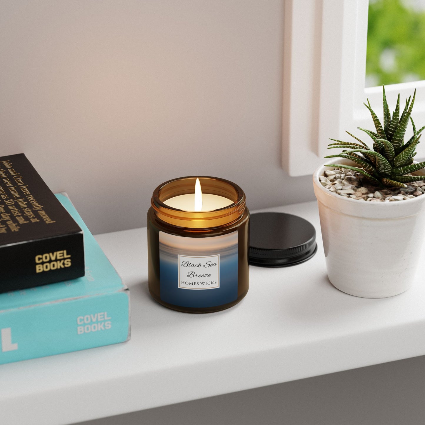 Candle in a glass jar on a shelf with books and a plant