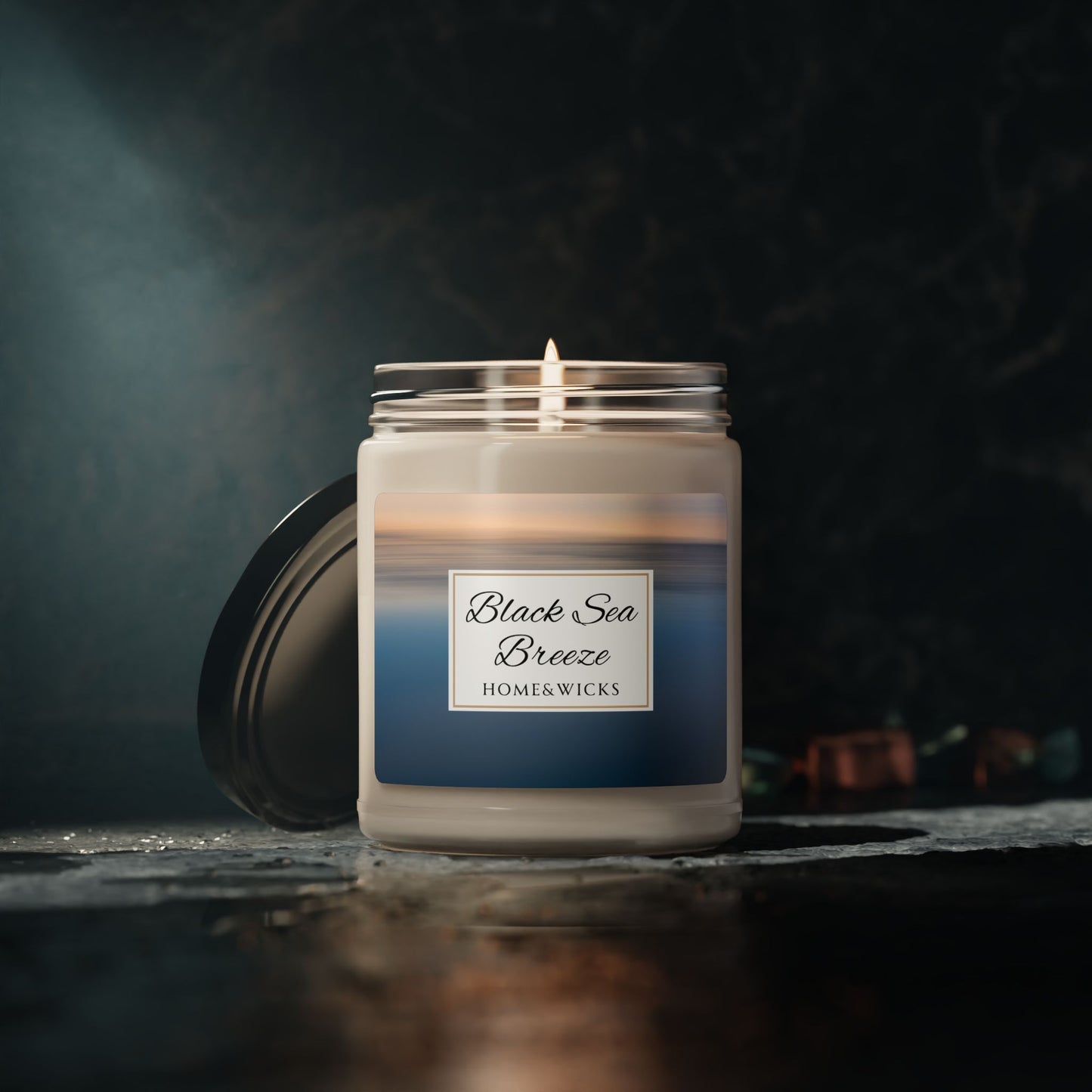 Candle labeled 'Black Sea Breeze' by Home&Wicks on a dark background