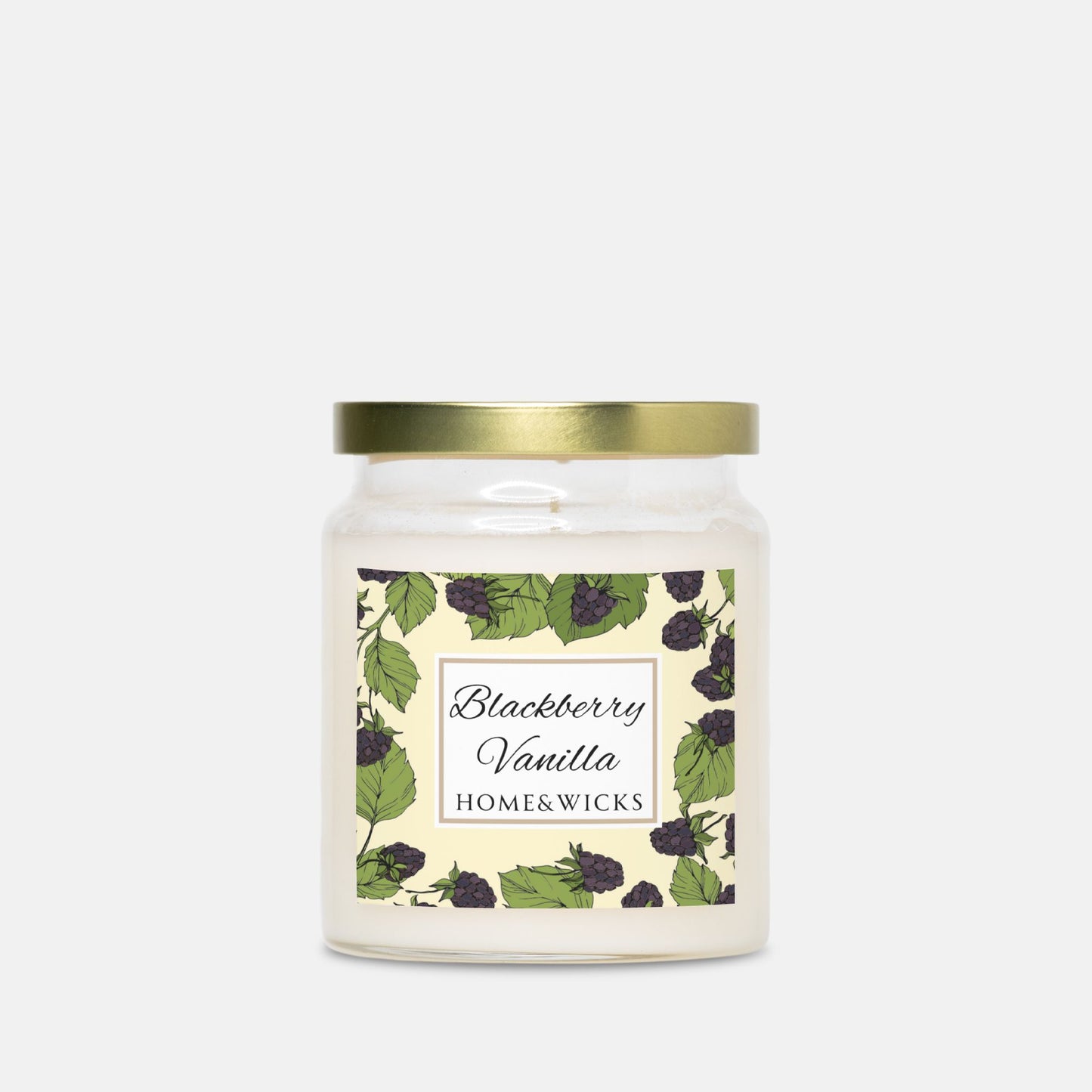 Candle jar with a label featuring blackberries and gold lid on a white background