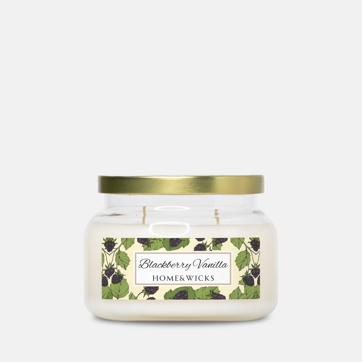 Double wick candle with a gold lid and blackberry vanilla label on a white background