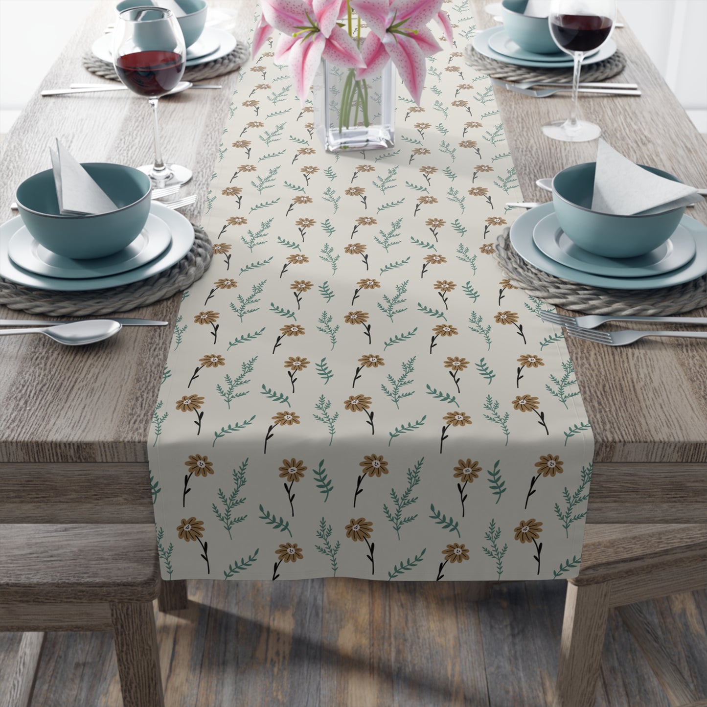 Table setting with our Brown Chamomile table runner that has a brown and gray floral patterned table runner on a wooden table.