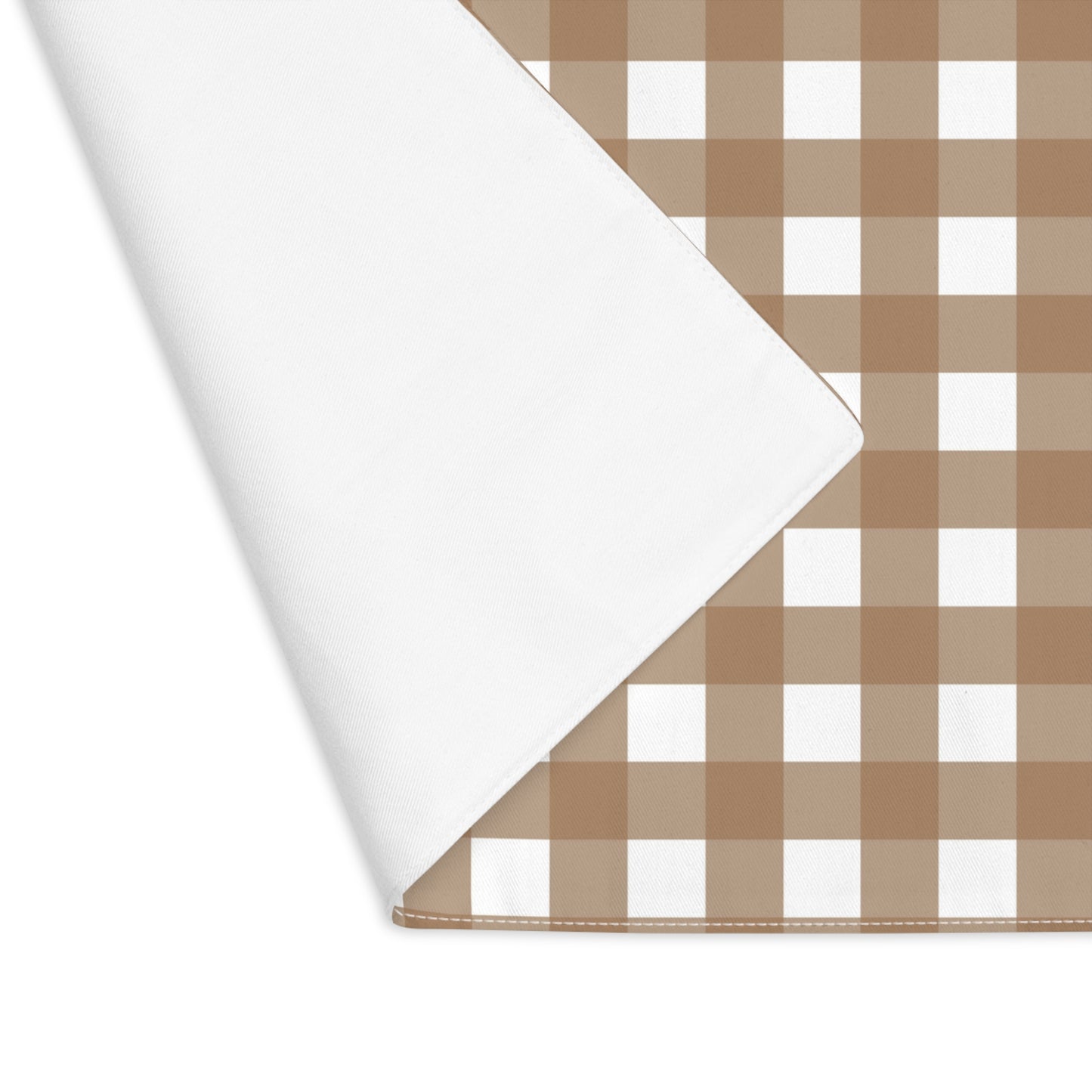 Our Brown Gingham placemat with corner folded to view back with a brown and white checkered fabric on a white background