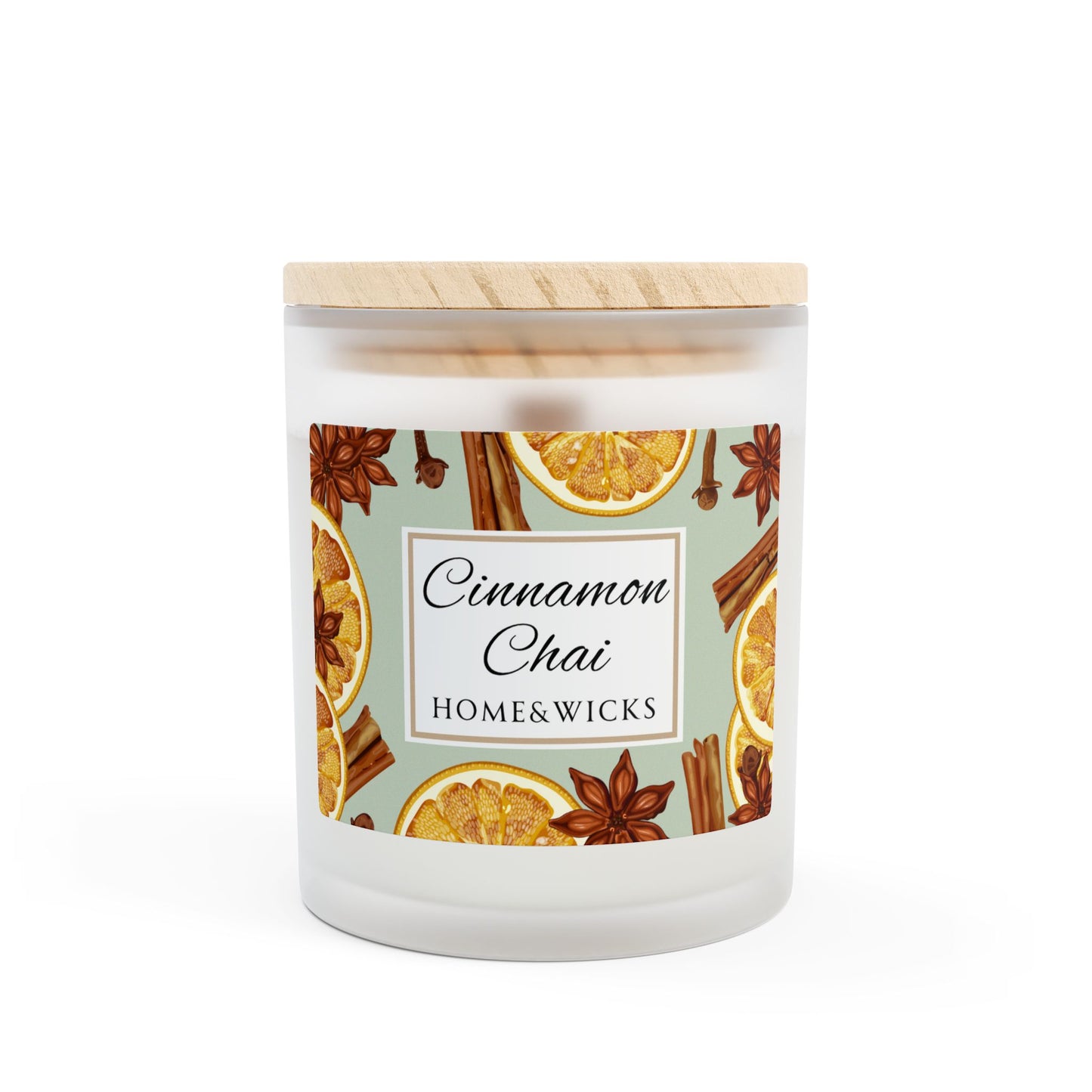 Candle with cinnamon, chai, and orange design on a white background