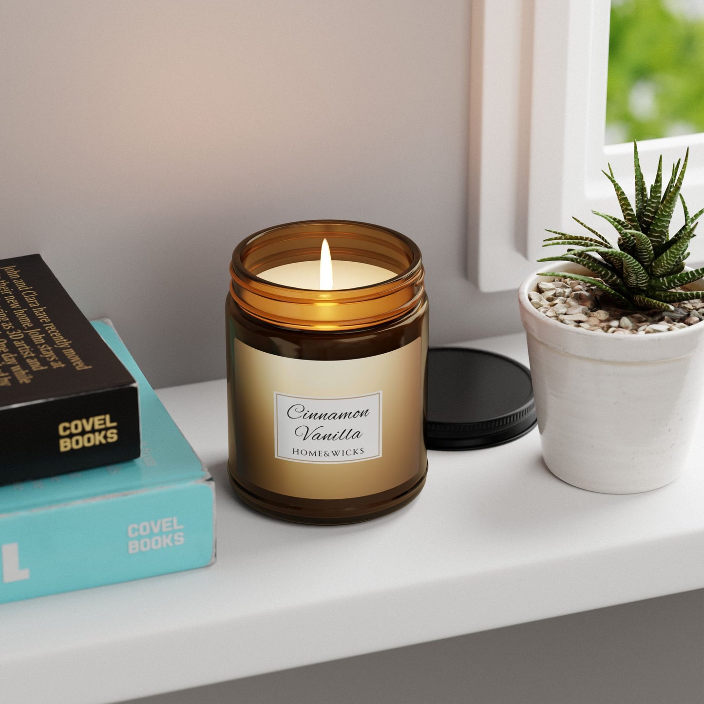 Candle labeled 'Cinnamon Vanilla' on a shelf with books and a plant