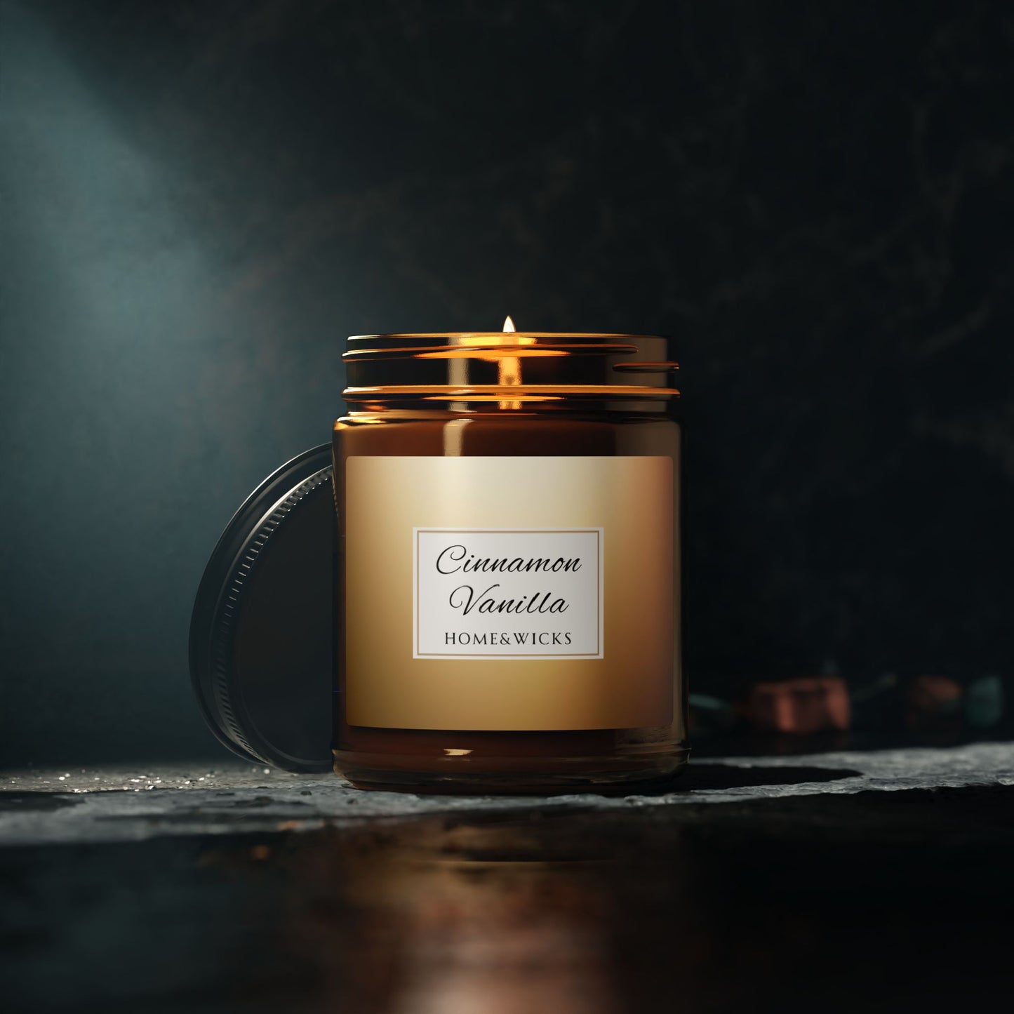 Candle in a jar labeled 'Cinnamon Vanilla' by Home & Wicks on a dark background