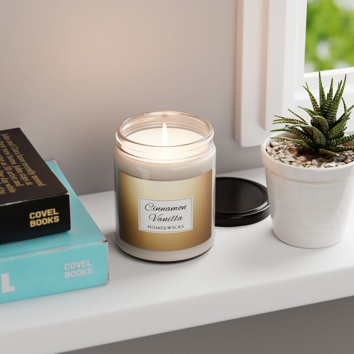 Candle labeled 'Cinnamon Vanilla' on a shelf with books and a plant