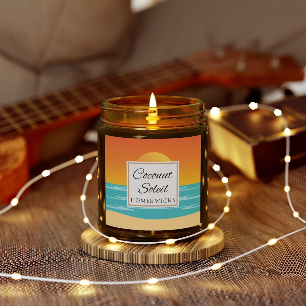 Coconut Soleil coconut apricot wax candle in an amber jar with gold lid with a colorful ocean sunset graphic label featuring 'Coconut Soleil' by Home & Wicks on a white background surrounded by string lights on a textured surface.