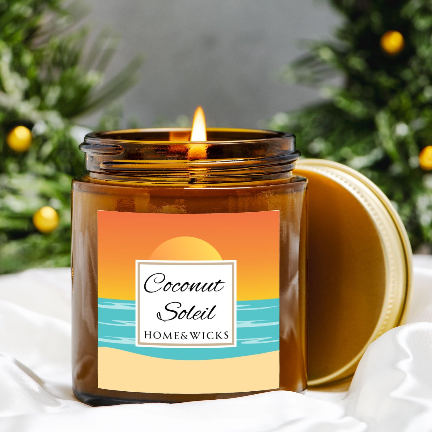 Coconut Soleil candle in 4 oz. amber glass jar with gold lid with a colorful sunset label on a white background by Home & Wicks with orange tree background