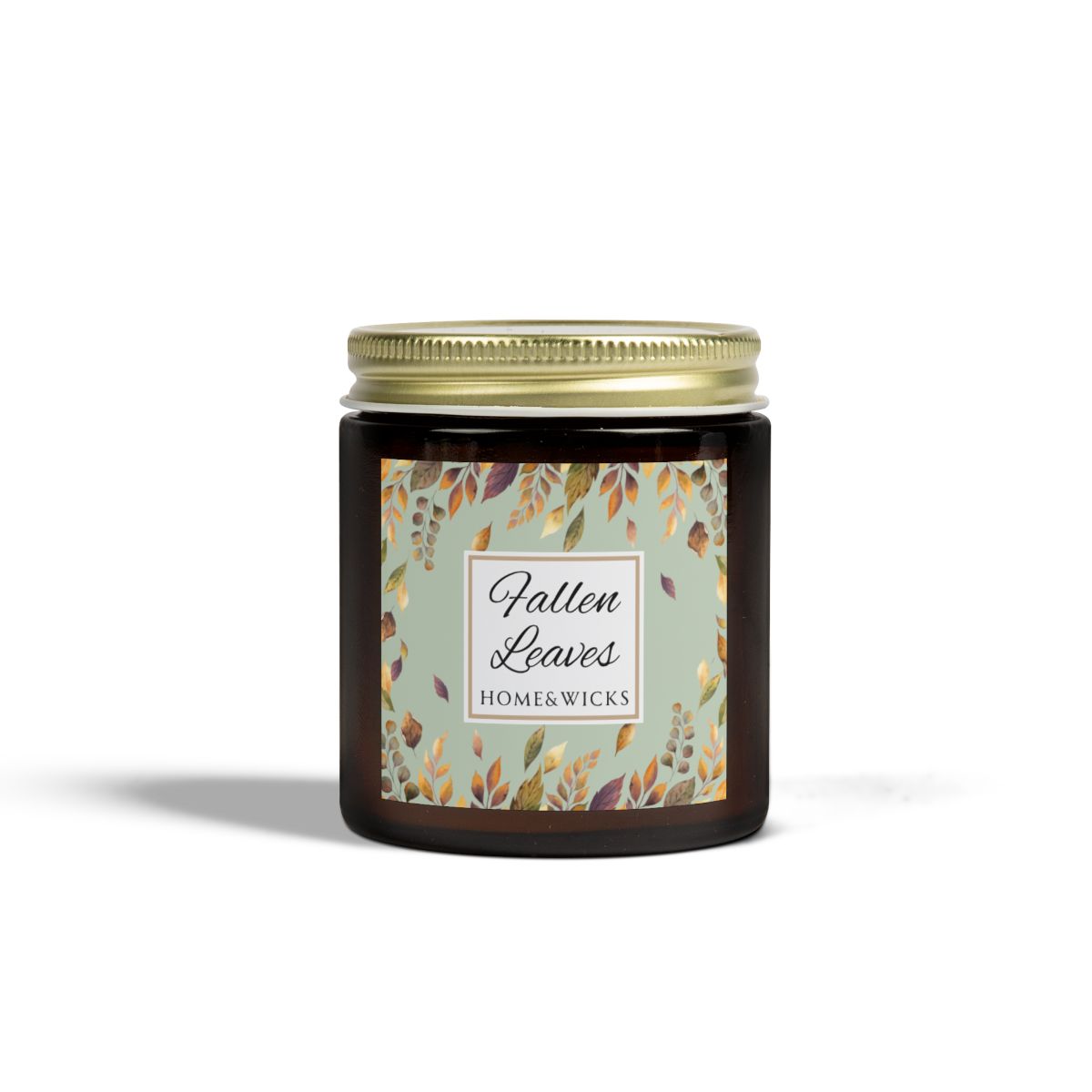 Fallen Leaves candle in a 4 oz. amber glass jar with gold lid with a 'Fallen Leaves' label on a white background by Home & Wicks