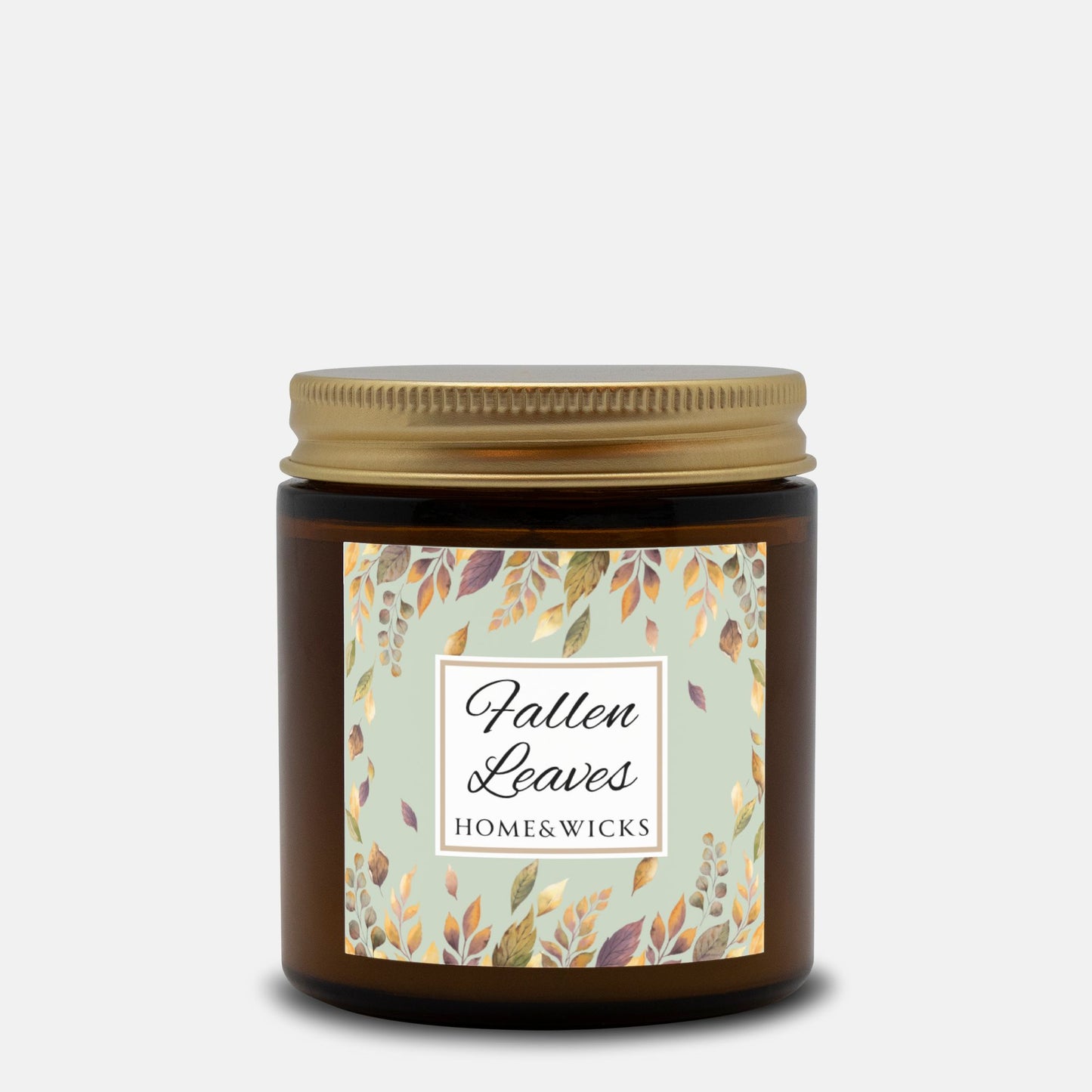 Fallen Leaves candle in a 4 oz. amber glass jar with gold lid with a 'Fallen Leaves' label on a white background by Home & Wicks