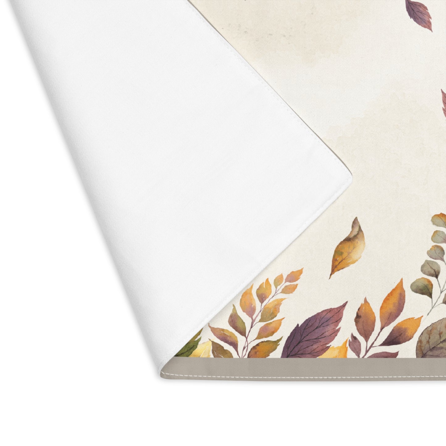 Back corner view of Fallen Leaves table runner with autumn leaf pattern on a white background