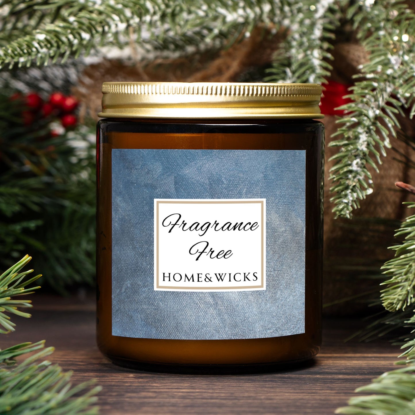 Unscented Candle in an amber jar with gold lid with 'Fragrance Free' label on a denim blue background with a 'Fragrance Free' label in front of Christmas decorations