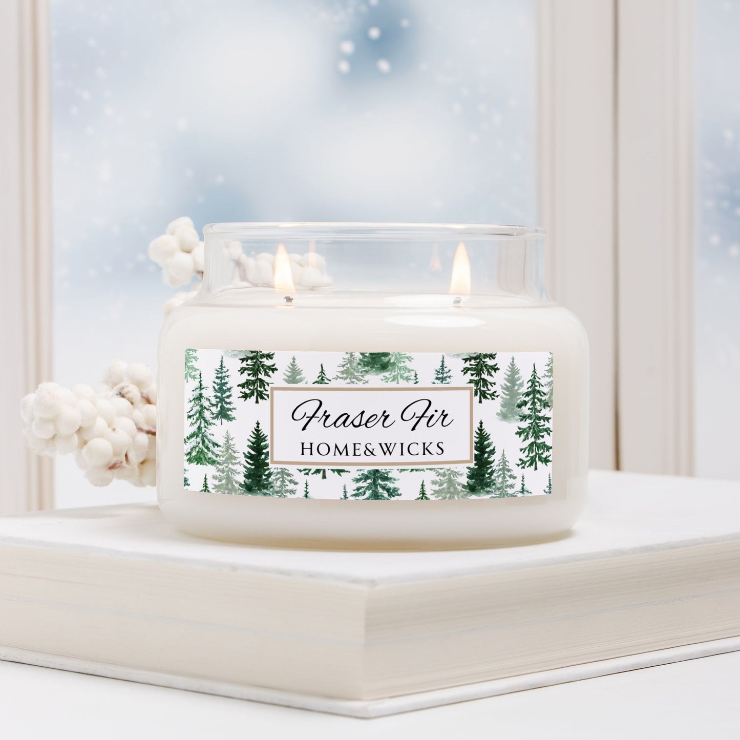 Home and Wicks Fraser Fir candle in a glass container with a snowy window background