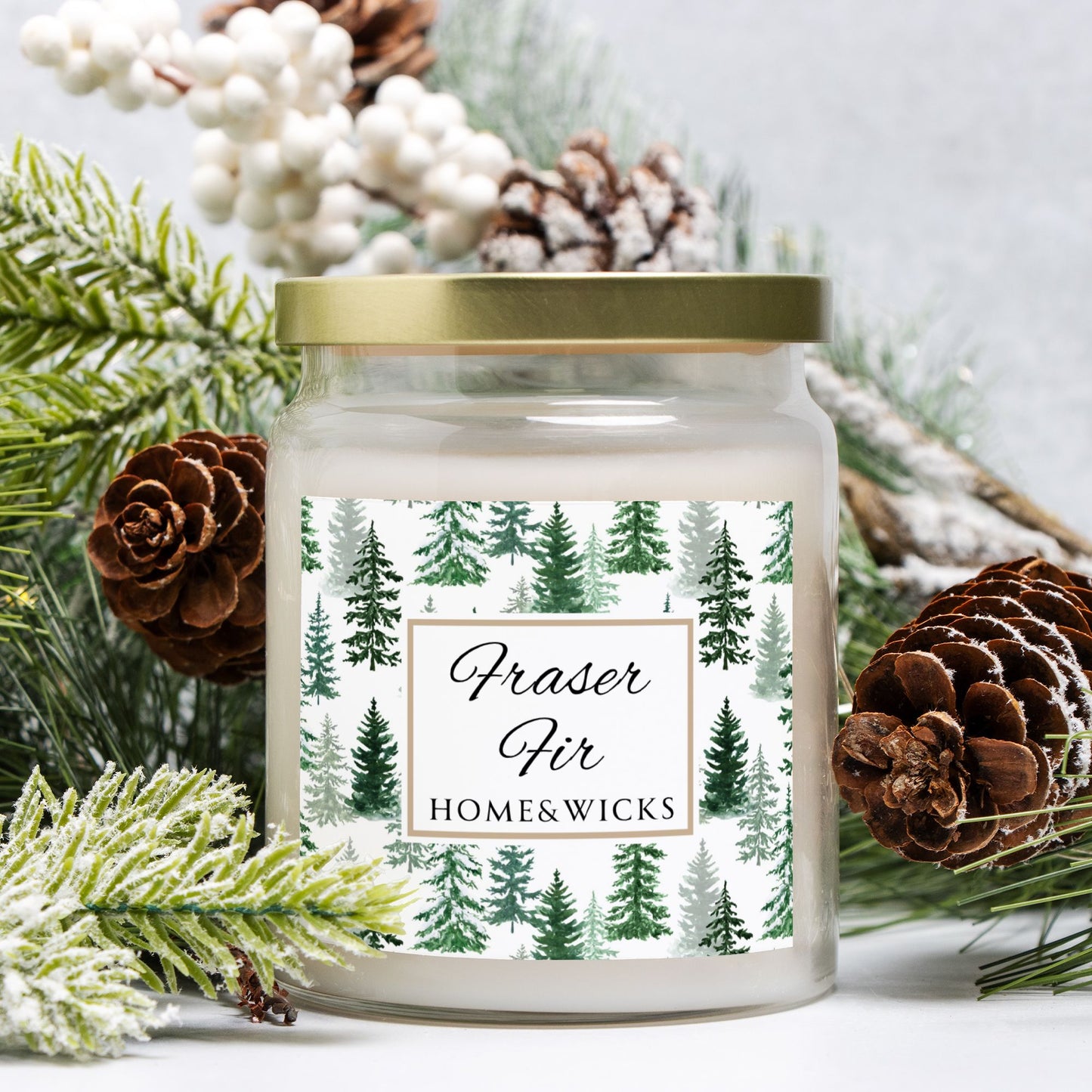Candle jar with a forest design label surrounded by pine cones and branches on a light background