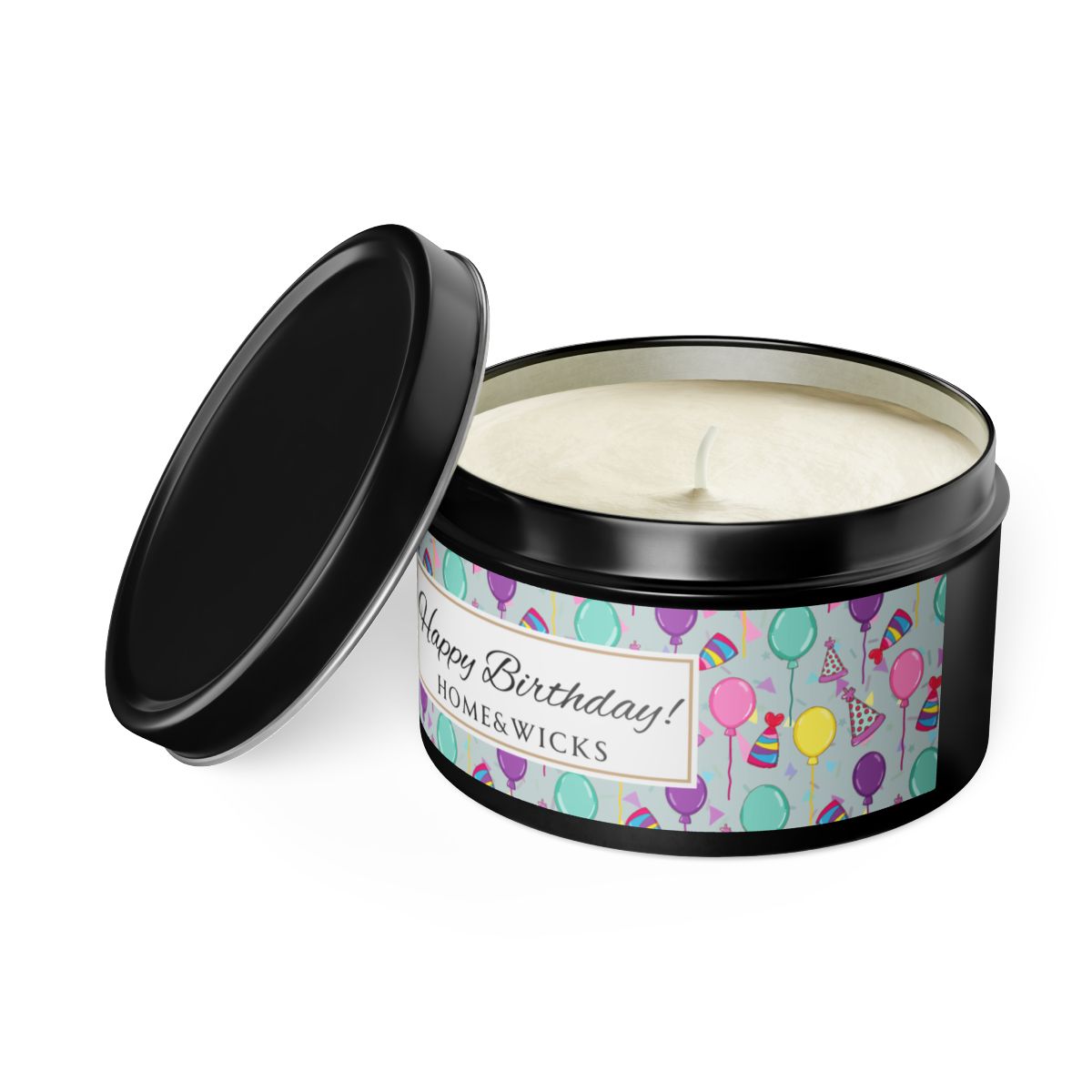 Open black candle tin with 'Happy Birthday' label with colorful balloon, birthday hats and confetti design on a white background