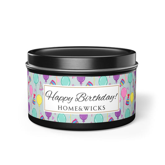 Black candle tin with 'Happy Birthday' label with colorful balloon, birthday hats and confetti design on a white background