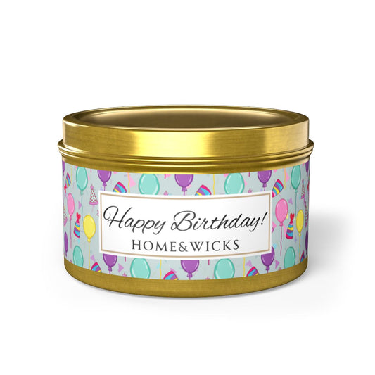 Gold candle tin with 'Happy Birthday' label with colorful balloon, birthday hats and confetti design on a white background