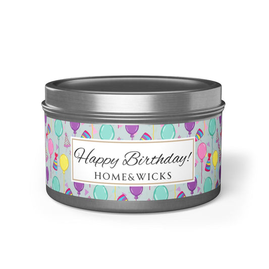 Silver candle tin with 'Happy Birthday' label and colorful balloon, birthday hats and confetti design on a white background