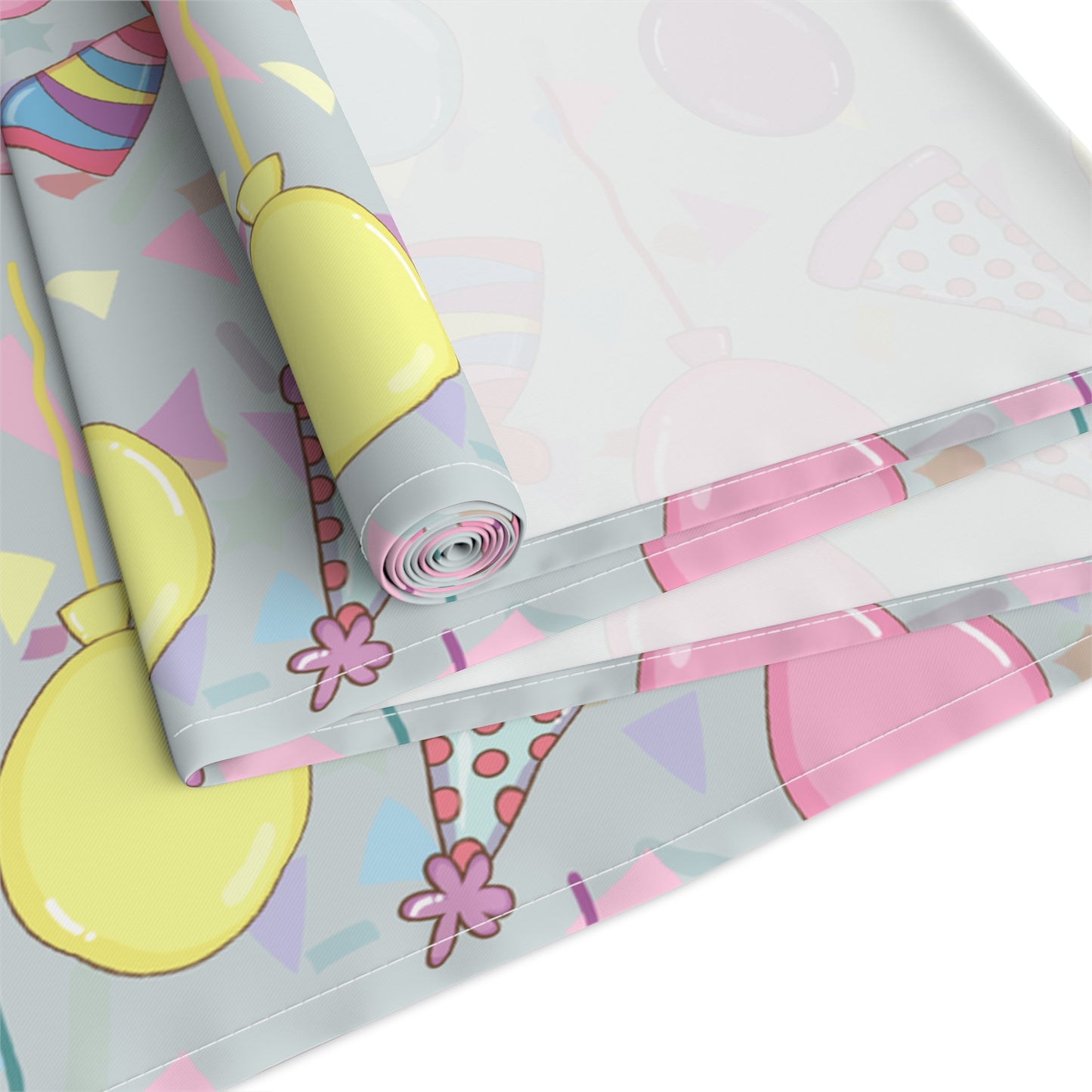 Table runner roll with colorful birthday party hats, confetti and balloons pattern on a white background