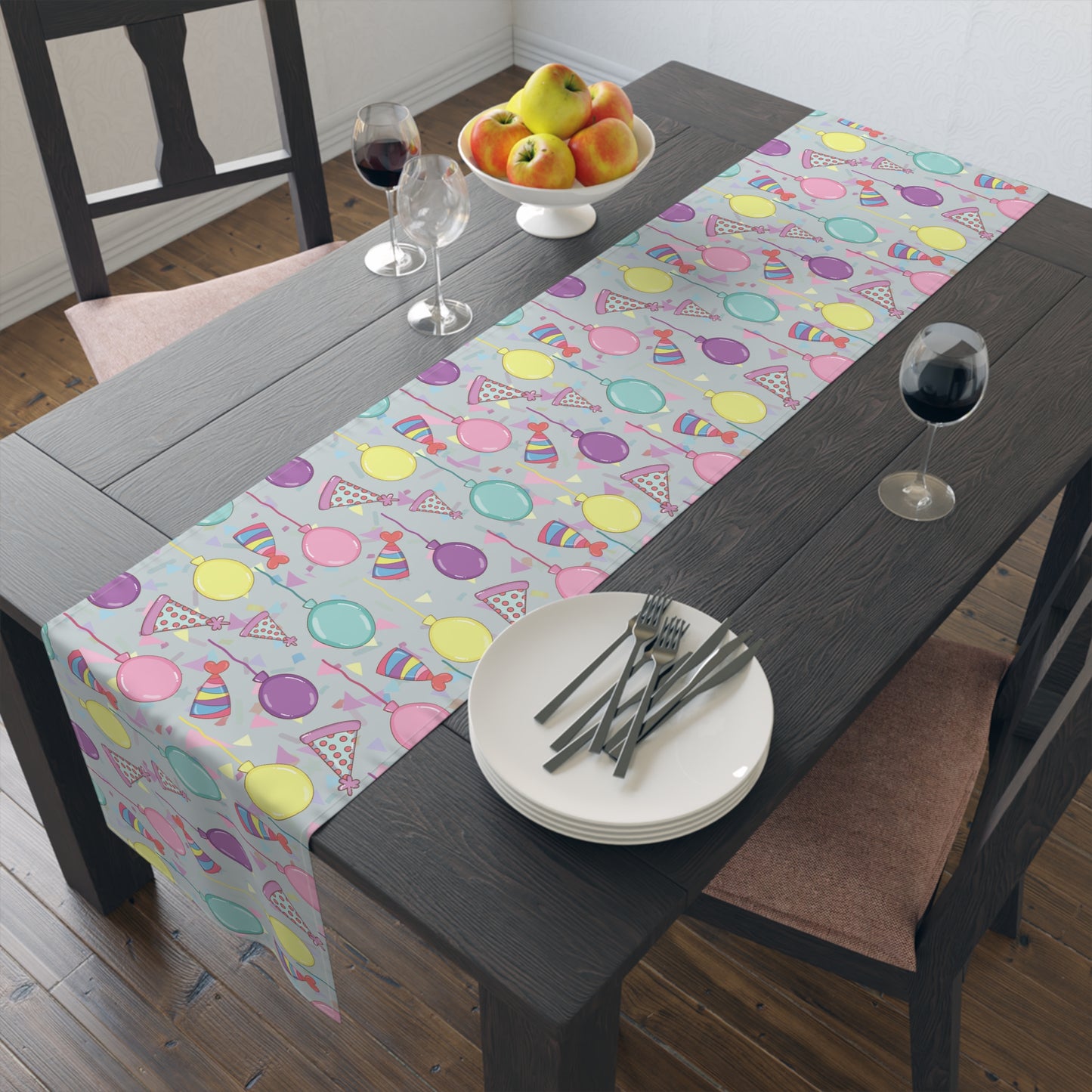 Table runner with colorful birthday party hats, confetti and balloons pattern on a dining table