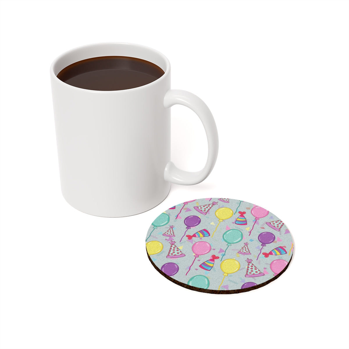 Round Happy Birthday! coaster with colorful balloons, birthday party hats and confetti pattern with a light blue gray background with white mug with coffee on a white background