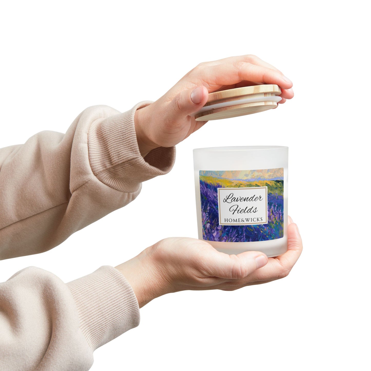 Person holding a 'Lavender Fields' candle with a scenic label against a white background