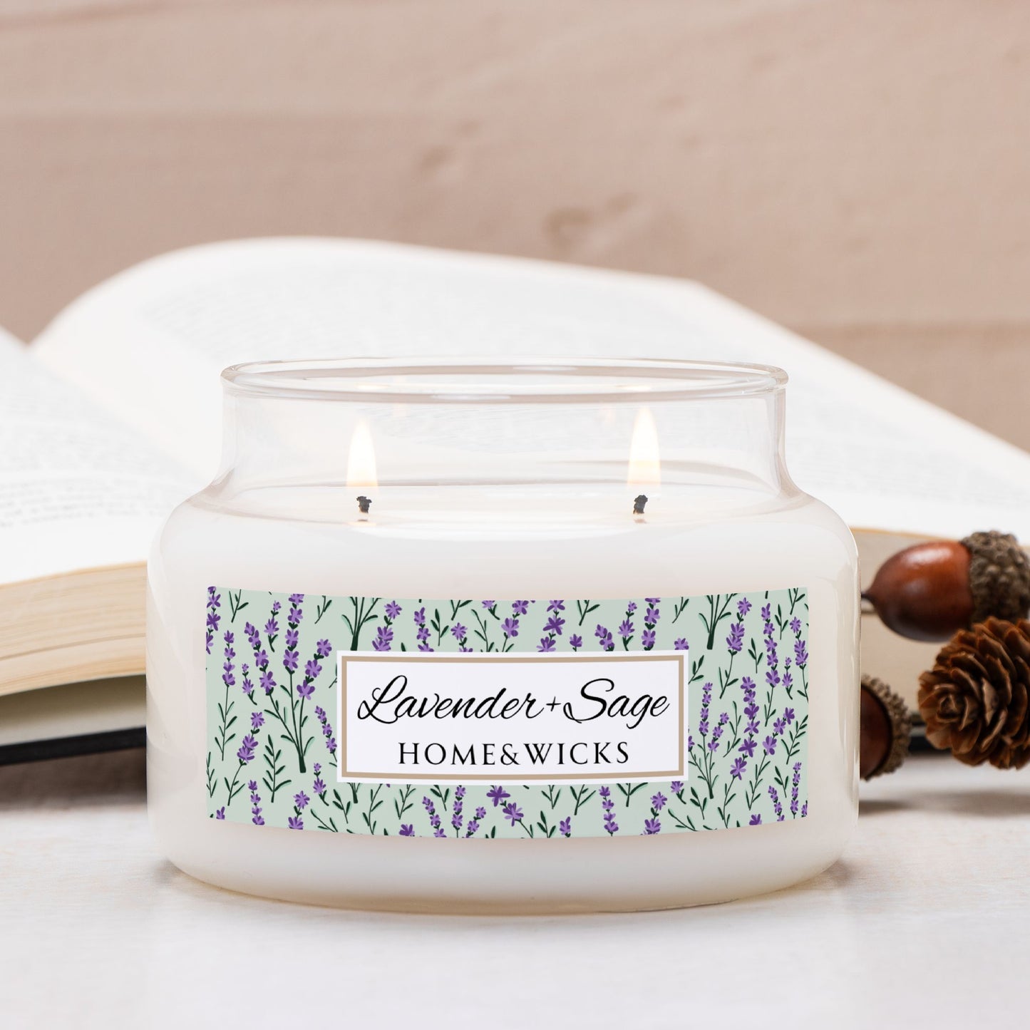 Double wick apothecary candle in a glass jar with a 'Lavender & Sage' label on a white surface.