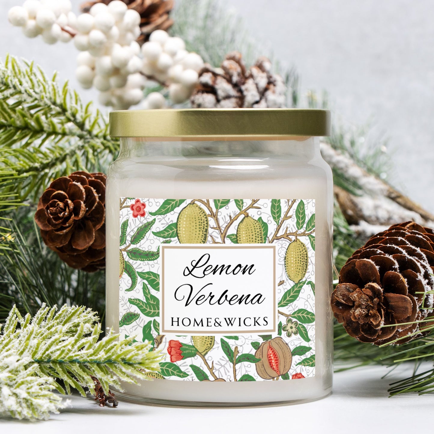 Candle jar labeled 'Lemon Verbena' by Home & Wicks surrounded by decorative elements on a light background