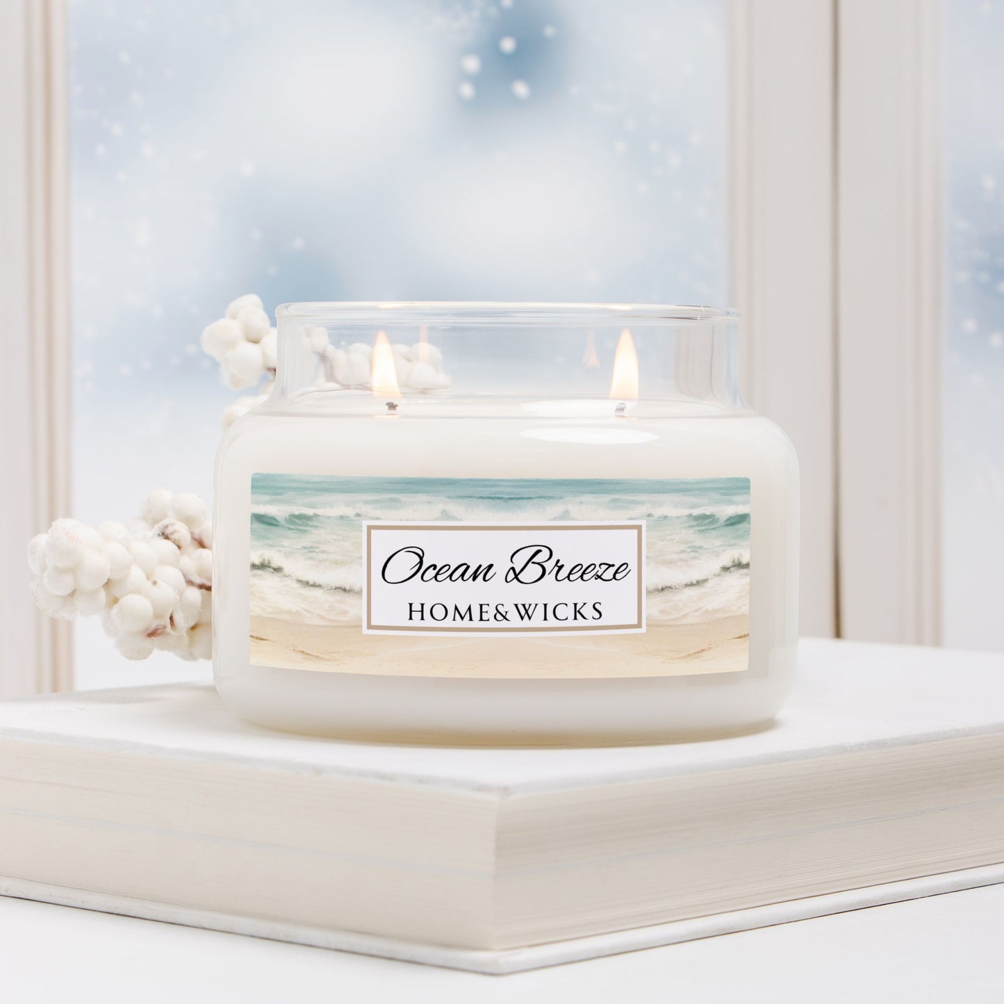 Candle labeled 'Ocean Breeze' by HOME&WICKS on a decorative stand with a beach scene background.