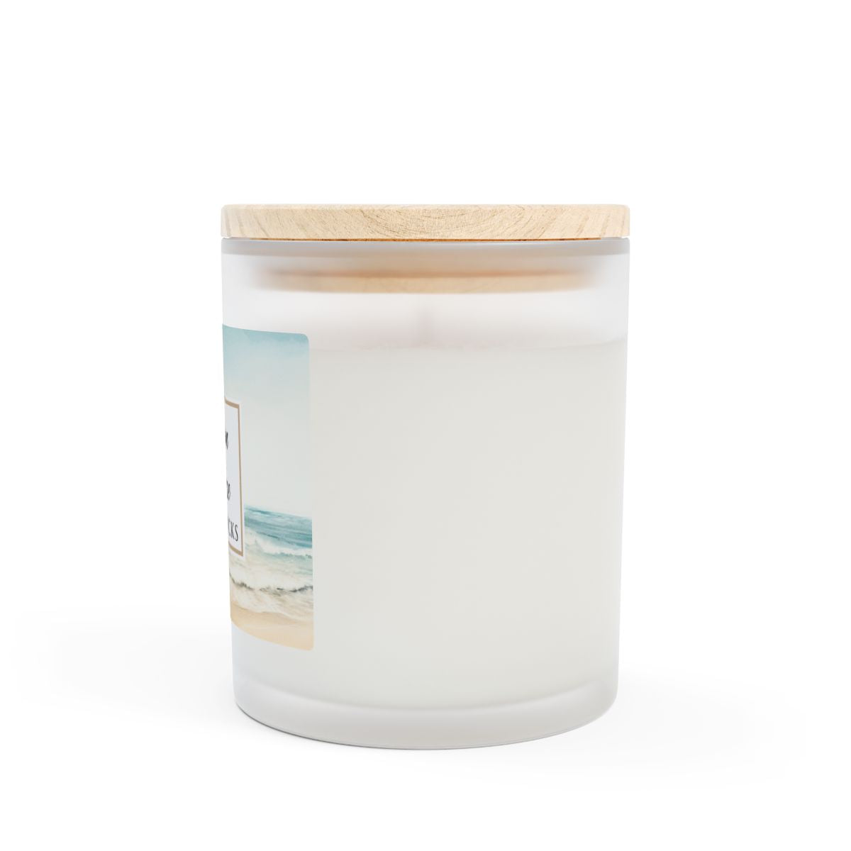 Side view of Ocean Breeze candle by Home & Wicks with a wooden lid on a white background