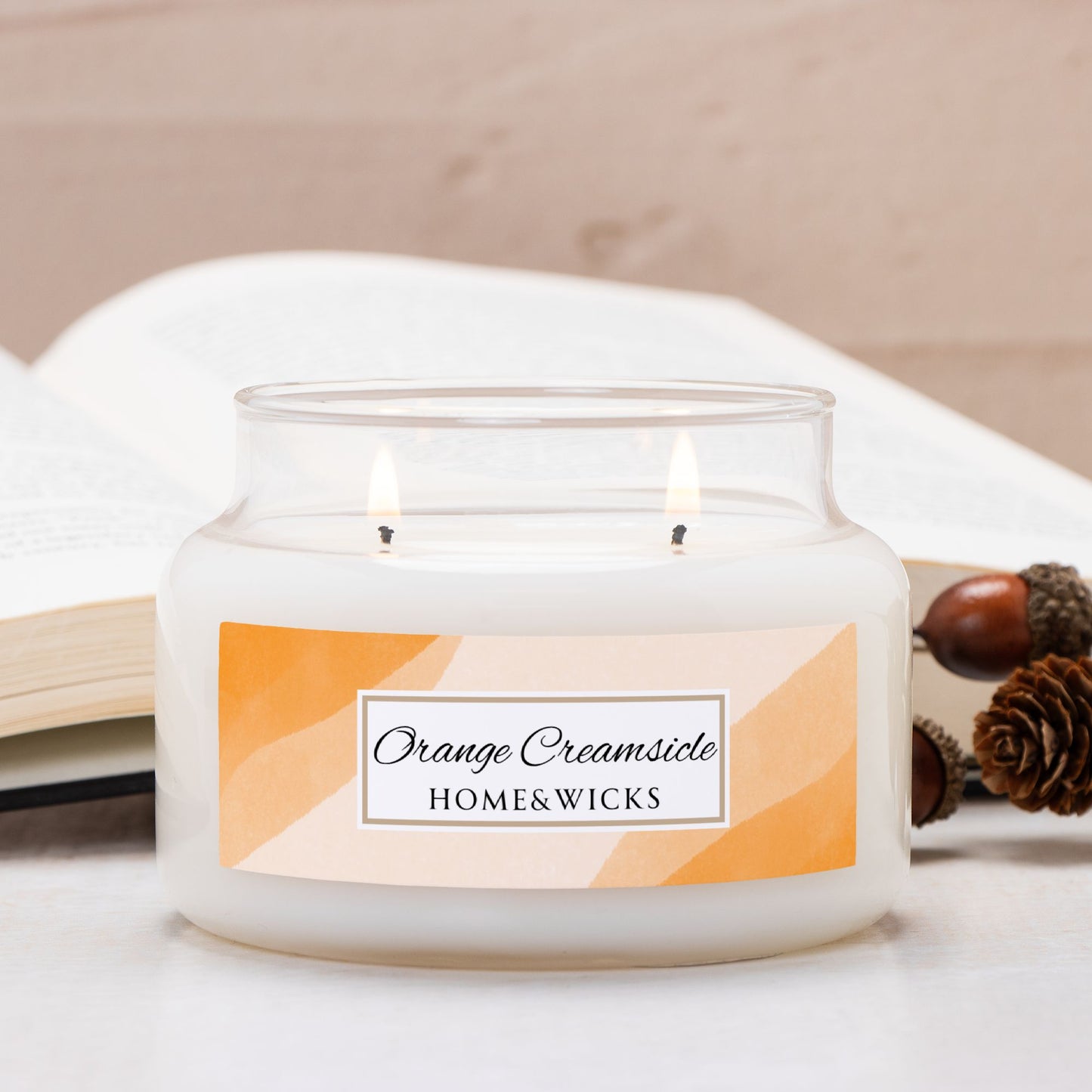 Home & Wicks Orange Creamsicle candle in a glass apothecary jar with a label, on a light background.