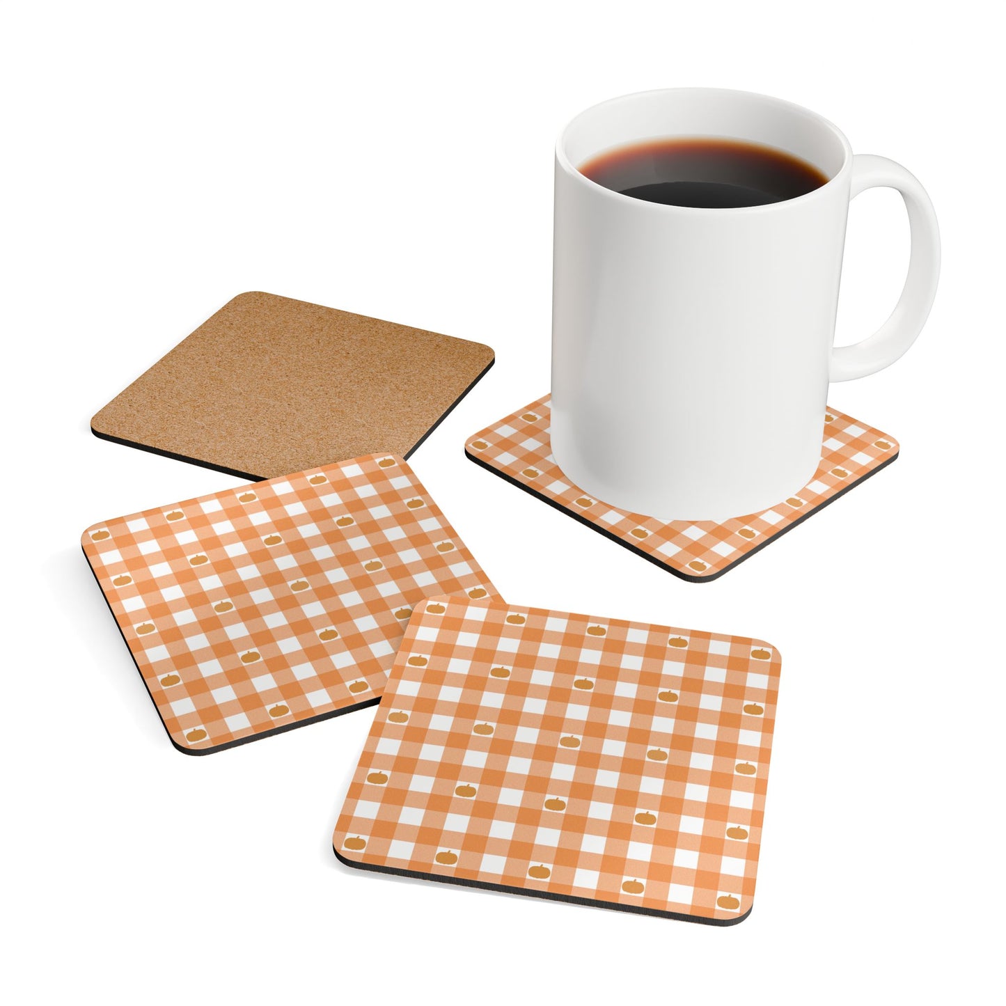 Set of four coasters with orange gingham and pumpkins pattern on a white background