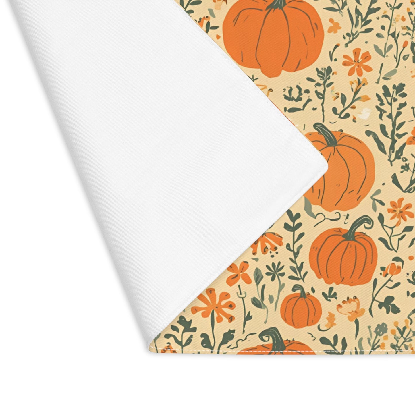 Our Pumpkin Garden cotton twill placemat has an orange pumpkins and flowers design with placemat edge folded over to reveal whit back