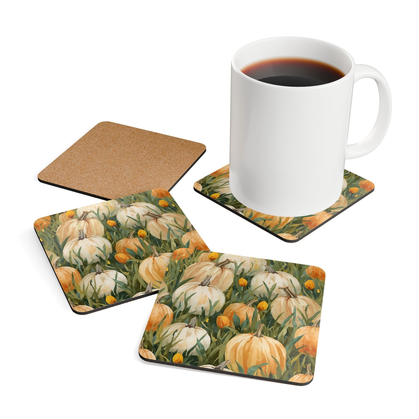 Set of four coasters with pumpkins in grass design, one coaster with a white mug containing coffee sitting on top.