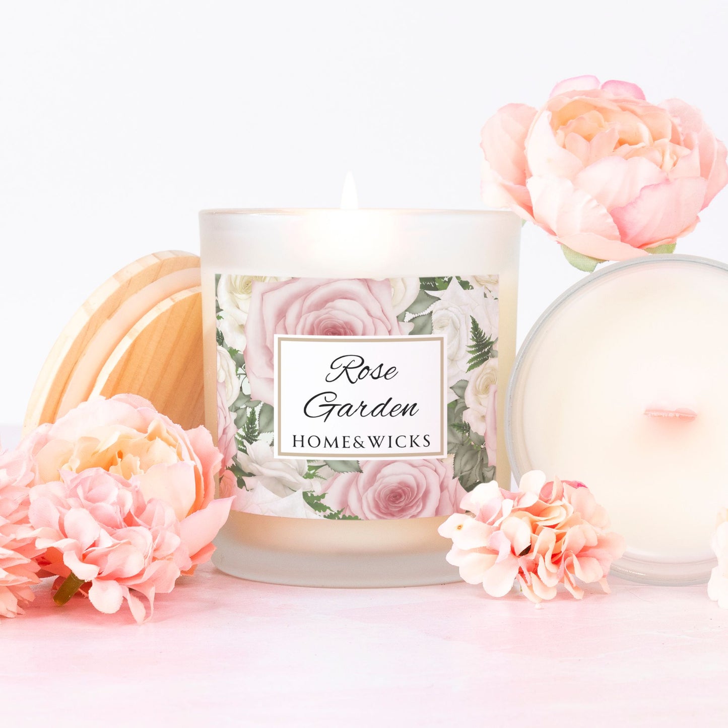 HomeWicks 'Rose Garden' candle with pink wood wick with floral design and pink flowers on a white background