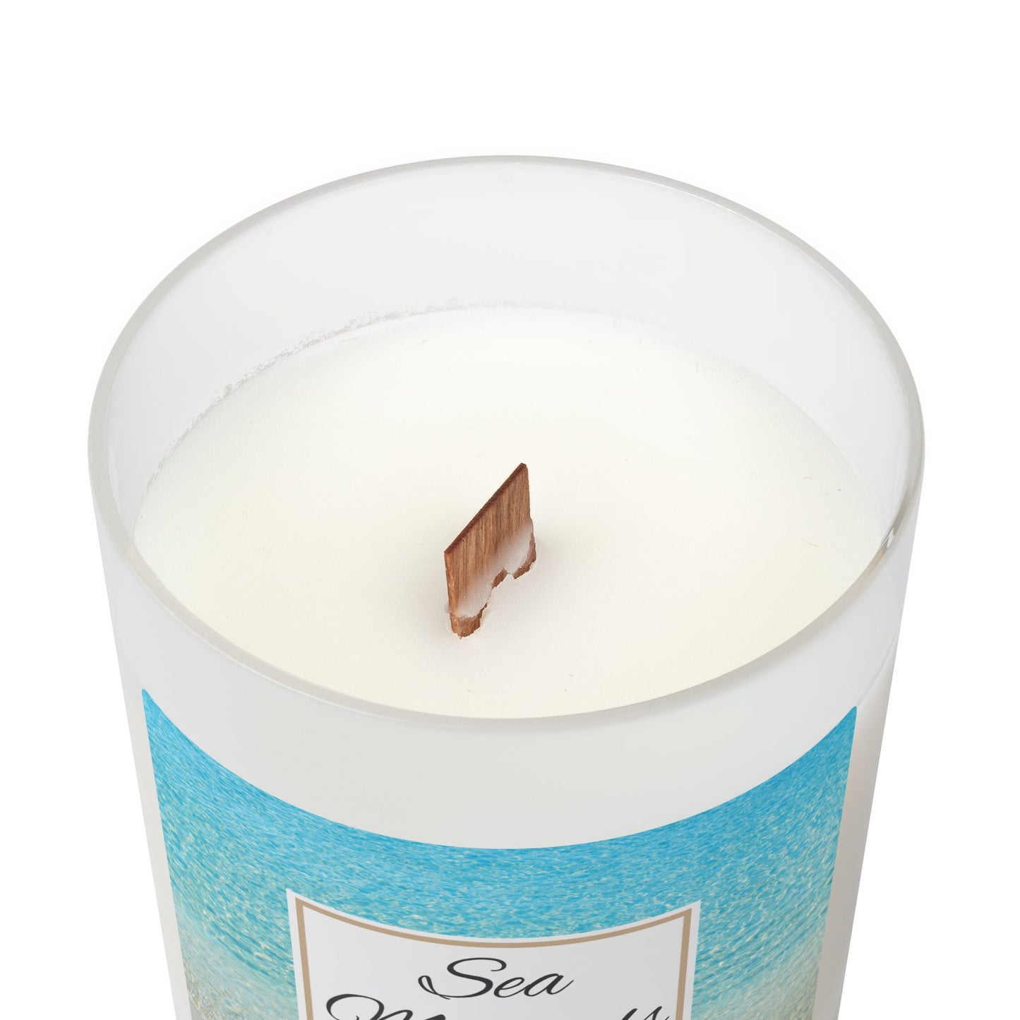 Candle with a blue label and wooden wick on a white background