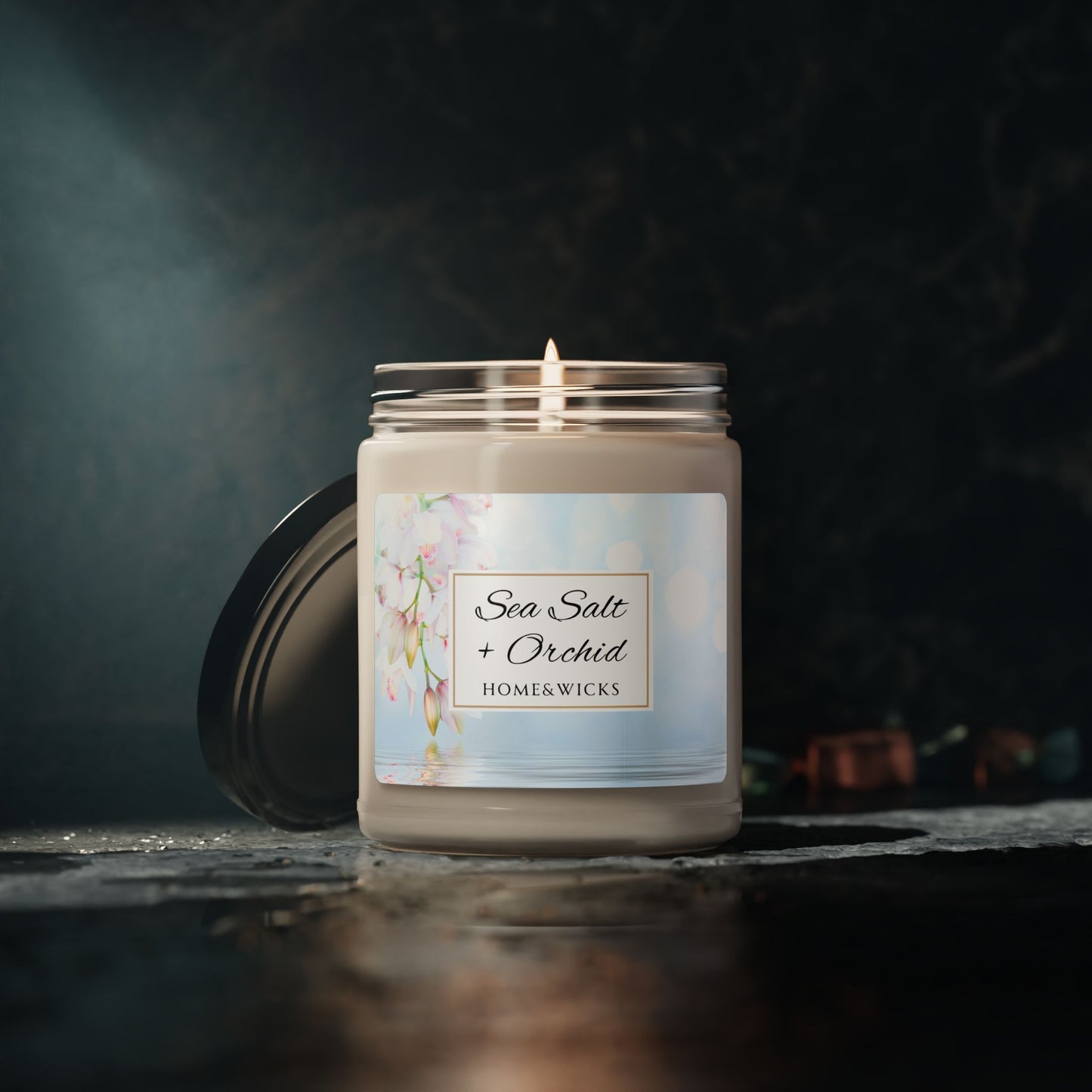 Homewares candle labeled 'Sea Salt + Orchid' by Homekwick on a dark background