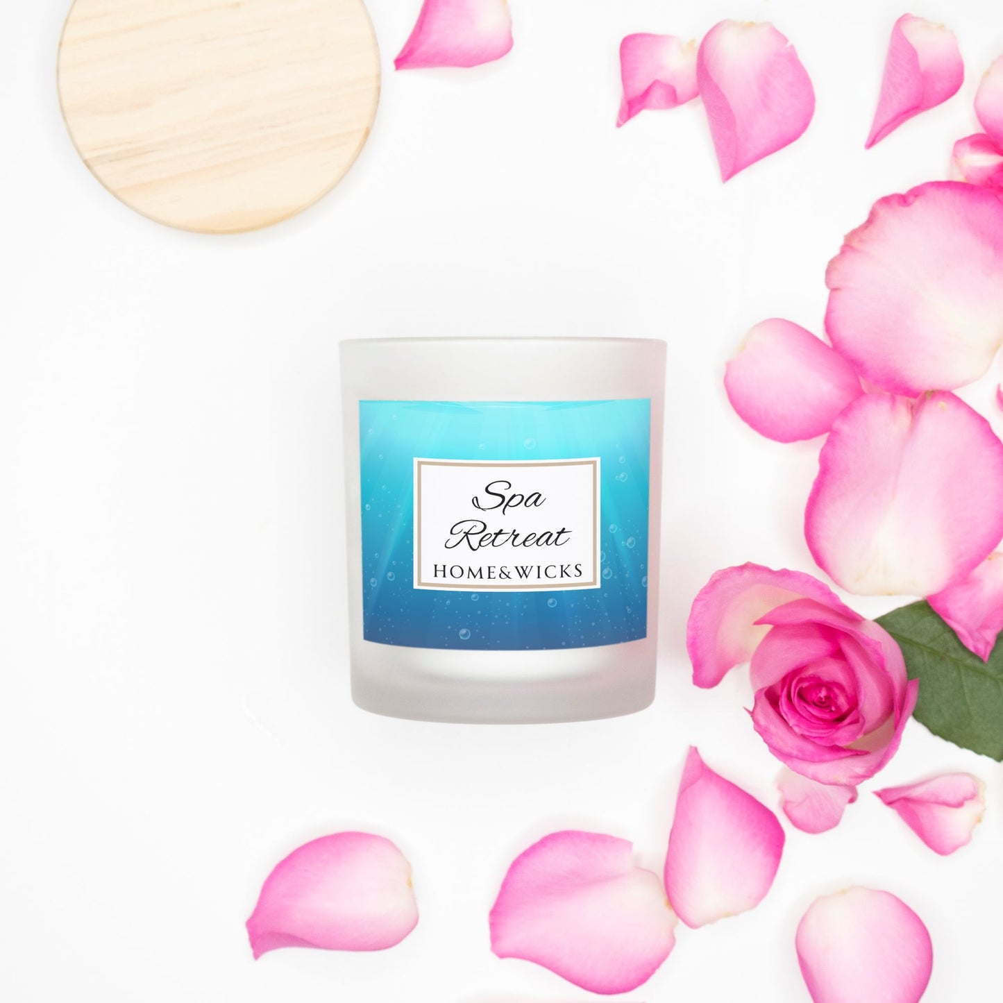 Candle labeled 'Spa Retreat' by Home & Wicks with pink rose petals on a white background