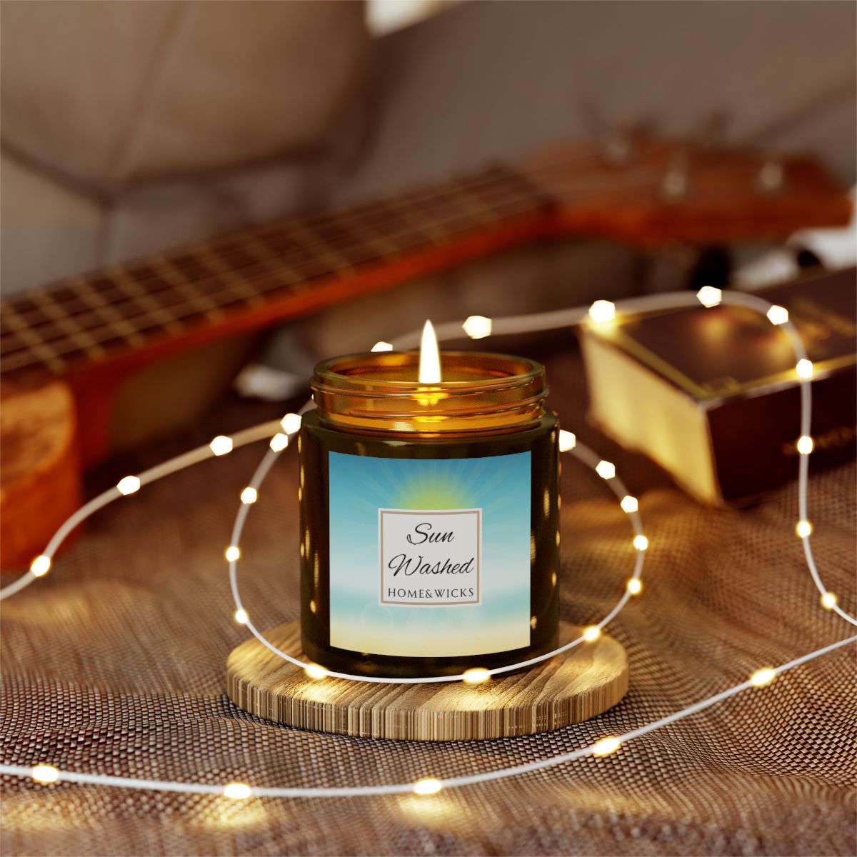 Sun Washed candle in a 4 oz. jar labeled 'Sun Washed' with sun graphic by Home & Wicks on a white background with string of lights
