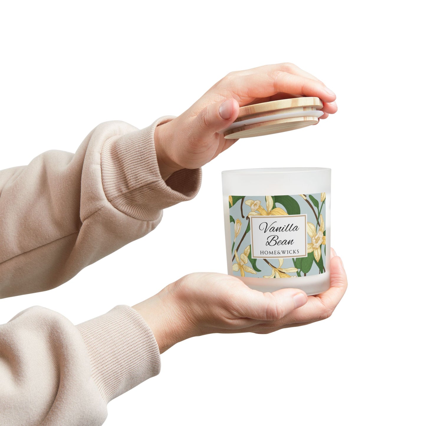 Person holding a Vanilla Bean candle with a matching lid against a white background