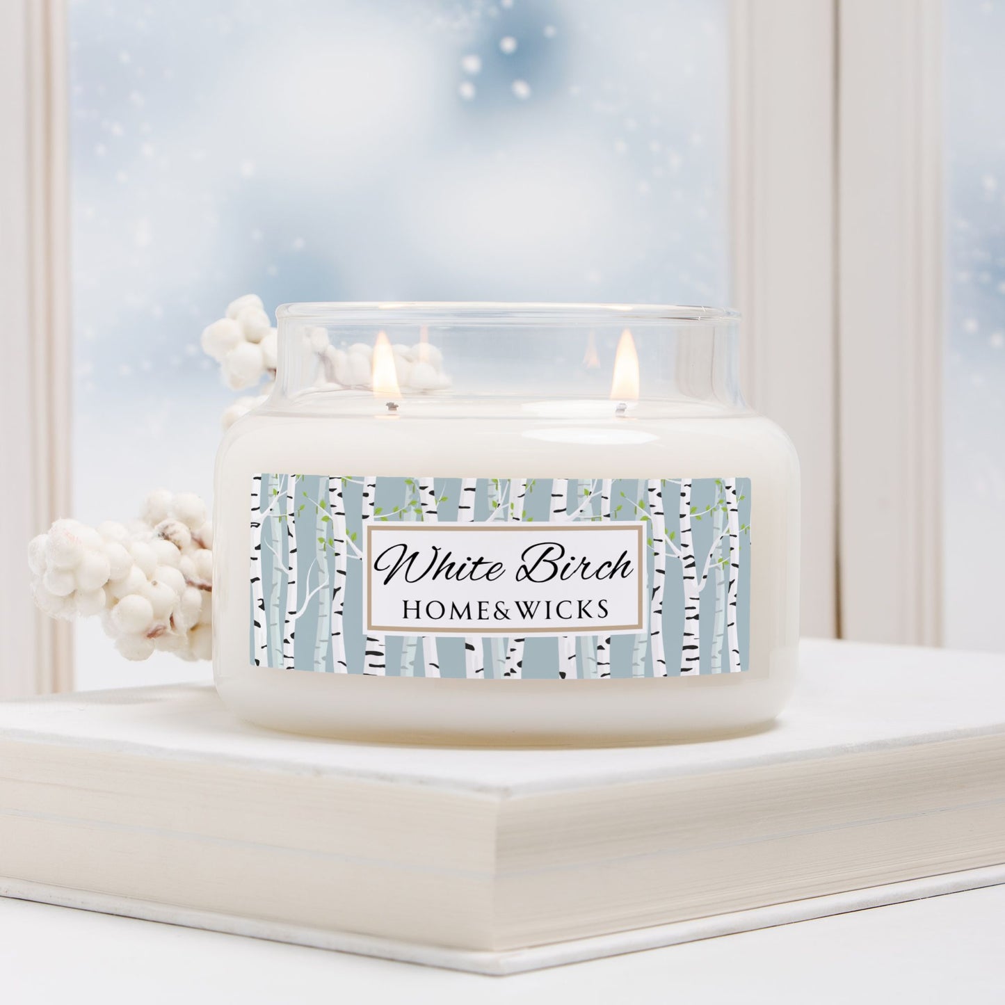 White Birch candle by Home & Wicks on a windowsill with a snowy background