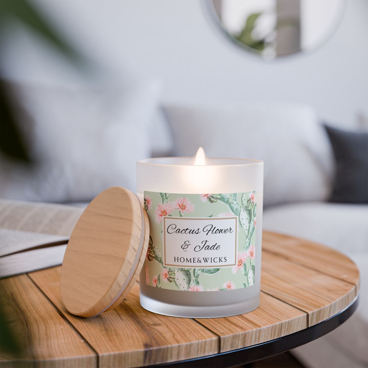 Lit wood wick candle labeled 'Cactus Flower & Jade' from Home & Wicks on a wooden table.