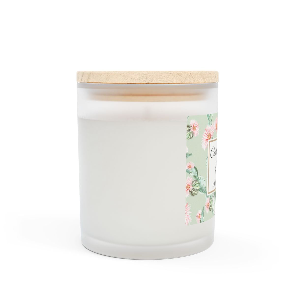 Side view of cactus flower white candle with a wooden lid and floral label on a white background
