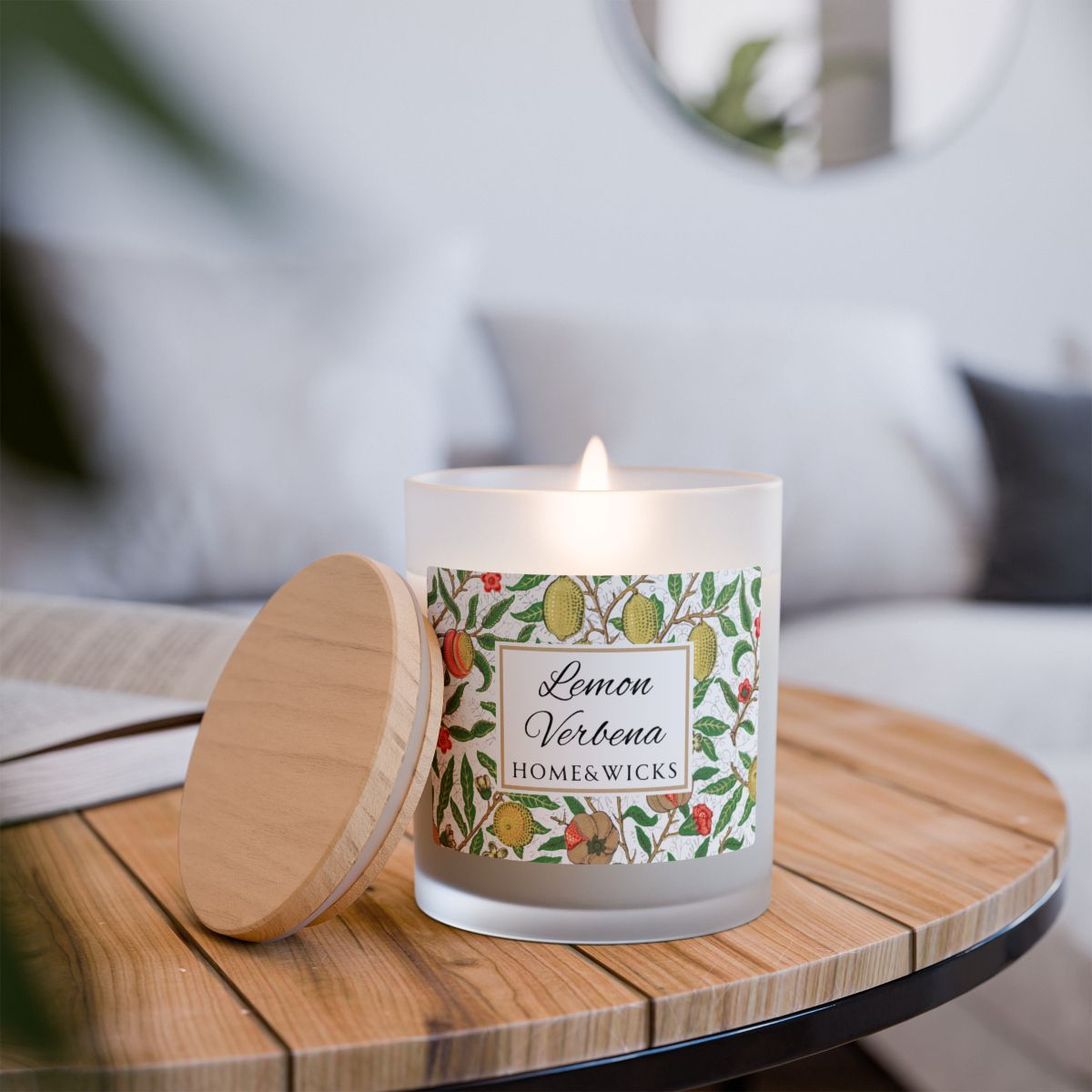 Wood wick candle with a decorative Lemon Verbena label featuring "fruit" by William Morris on a wooden table