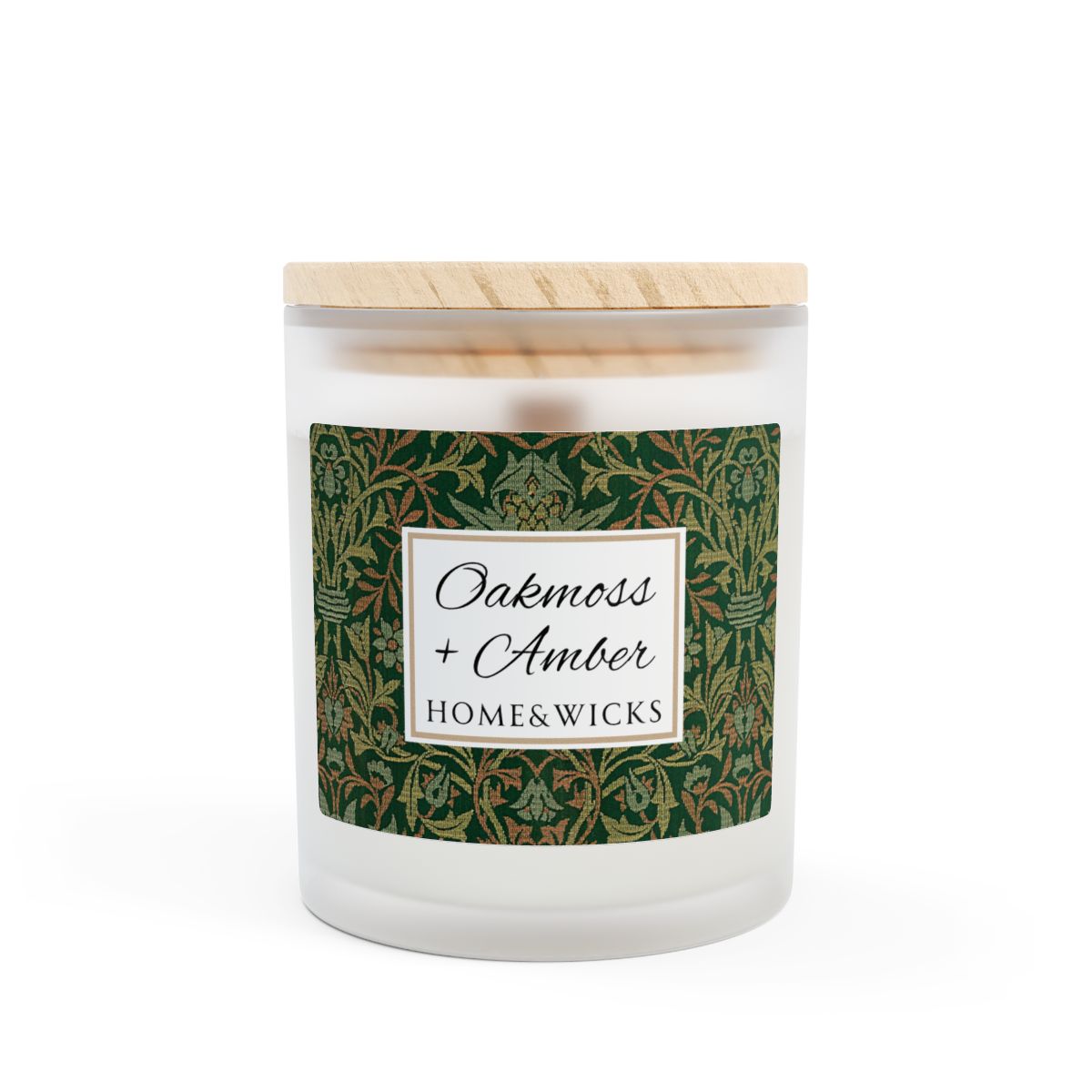 Wood wick Oakmoss & Amber candle in a frosted glass jar with a green decorative label featuring the illustration by William Morris "Flower Garden" on a white background by Home & Wicks